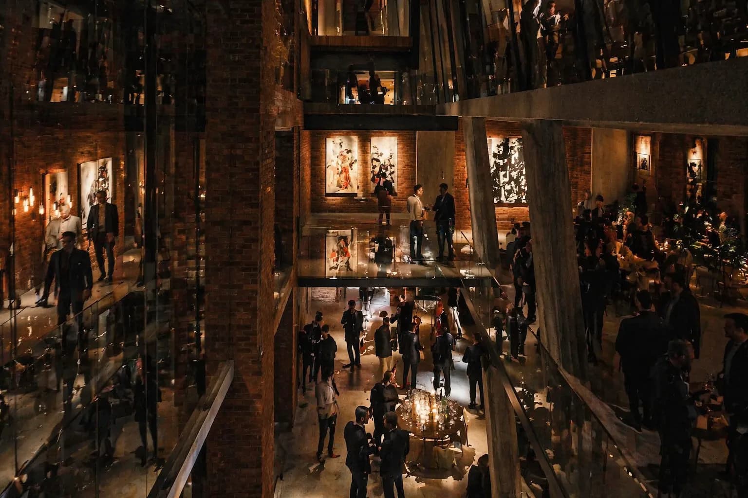 Art event atmosphere — candlelit room with live painting and audience